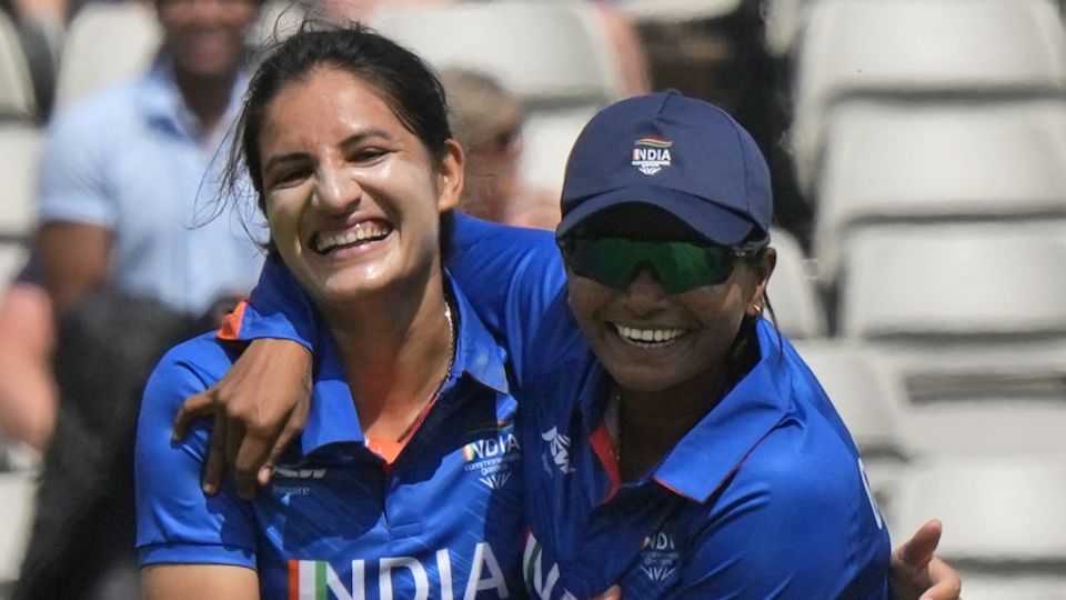 Renuka Singh Thakur (L) celebrates after dismissing Tahlia McGrath