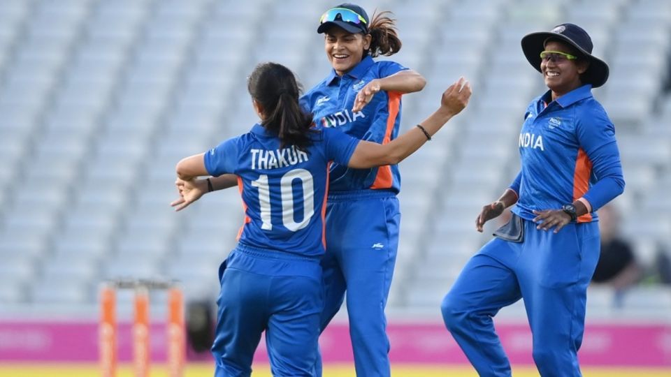 Radha Yadav and Deepti Sharma celebrate a wicket with Renuka Singh