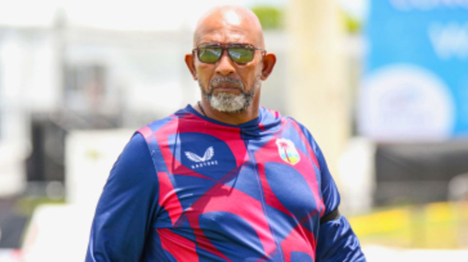 Phil Simmons walks on the outfield during the innings break