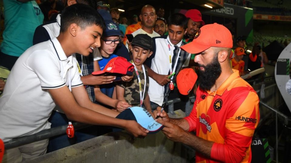Moeen Ali signs autographs after Birmingham Phoenix's victory over Trent Rockets