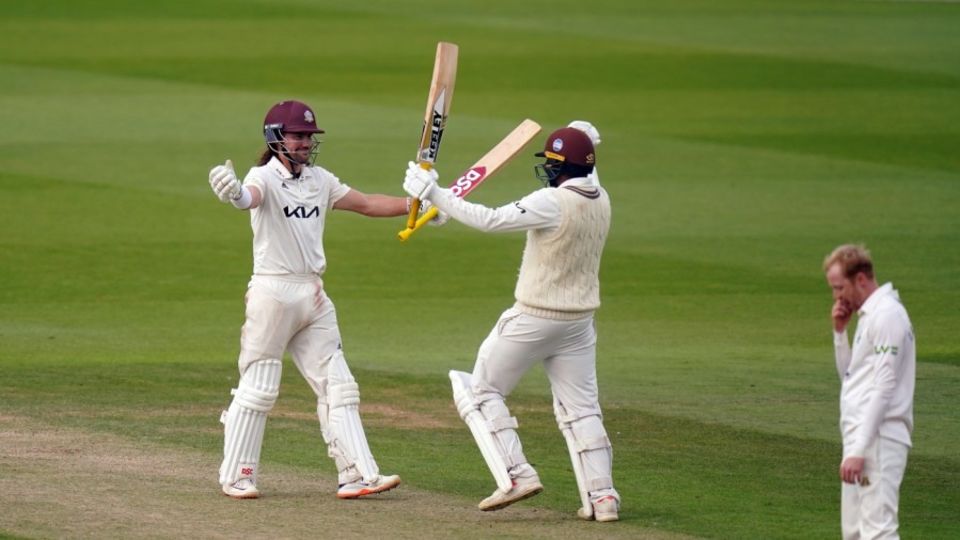 Rory Burns and Ryan Patel celebrate the moment of Championship victory