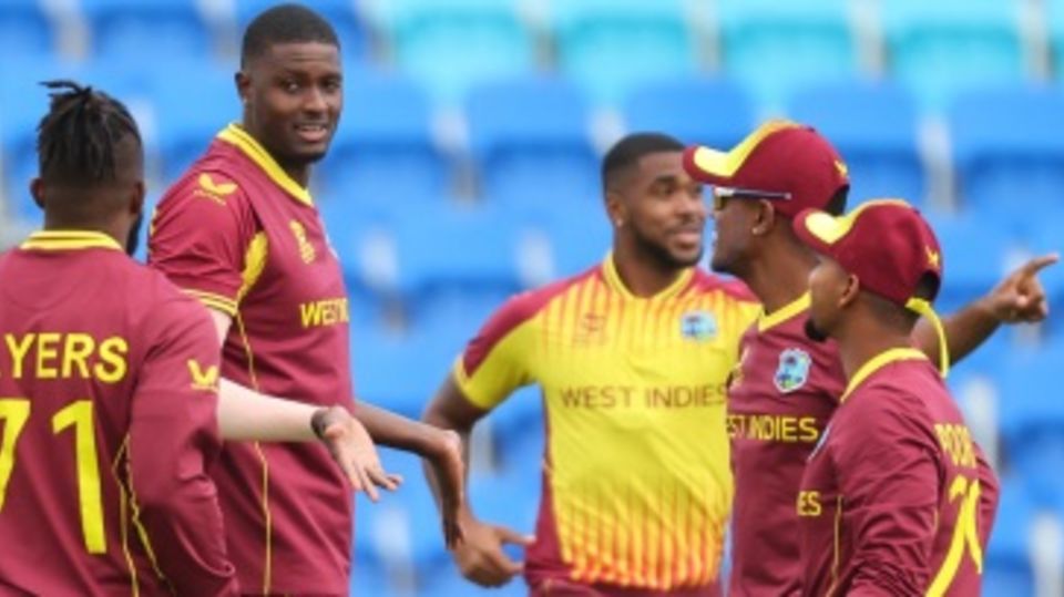 Jason Holder celebrates with his team-mates