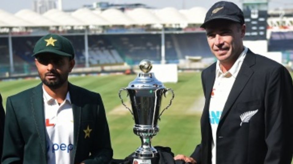 Babar Azam and Tim Southee pose with the trophy