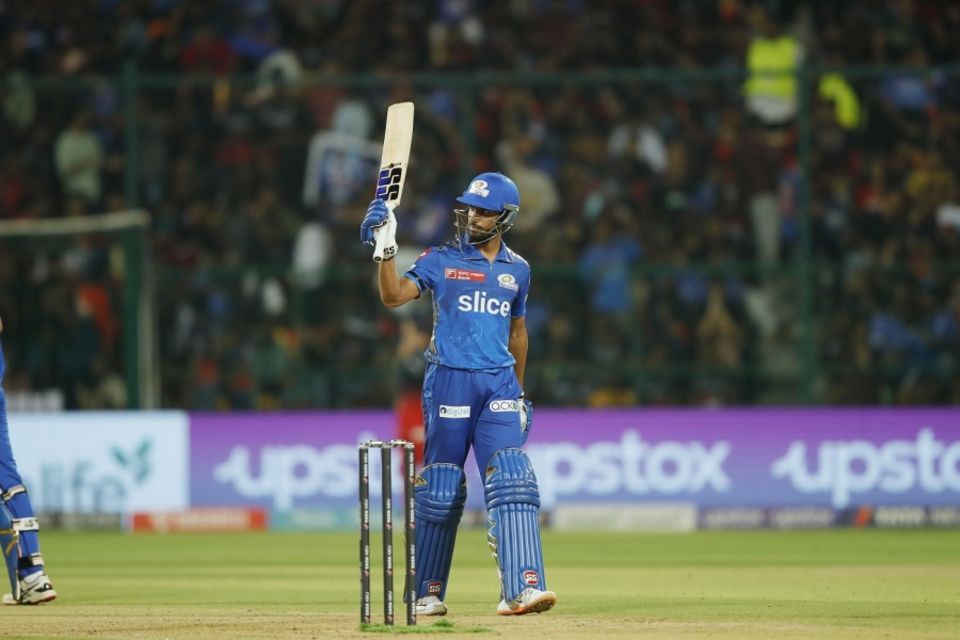 Tilak Varma raises his bat after reaching a well-deserved half-century