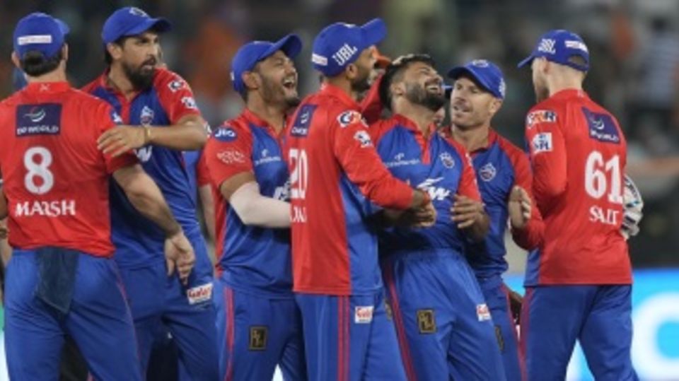 An elated Mukesh Kumar is mobbed by team-mates after he defended 12 runs in the final over