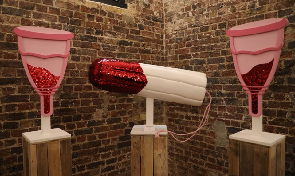 Models of a pair of menstrual cups and a tampon on display in a museum in London
