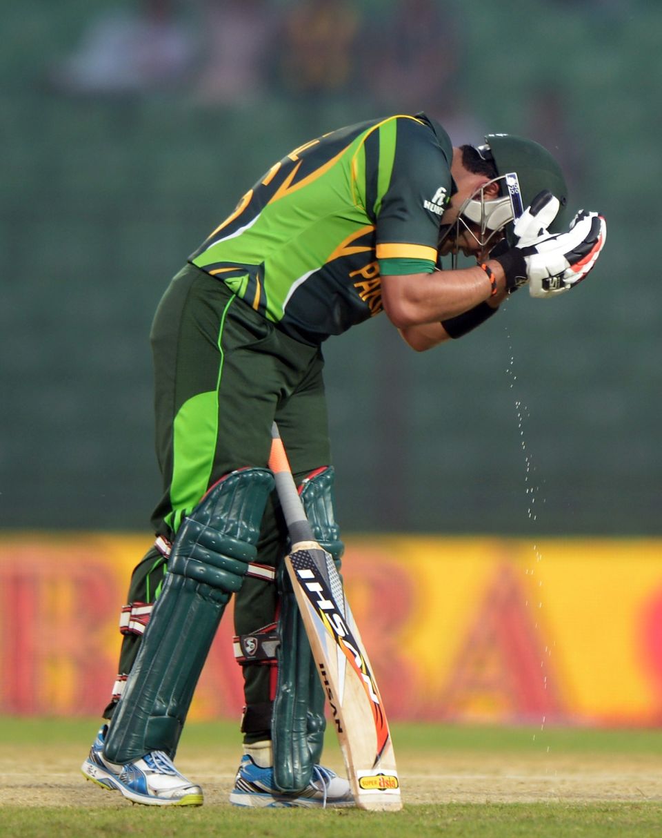 Umar Akmal adds some much-needed moisture to the pitch during the Asia Cup in Dhaka in 2014