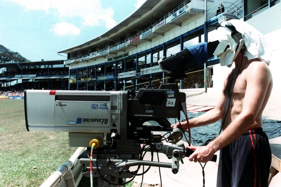 The sheet is on: a cameraperson works on his tan while on the job in Trinidad
