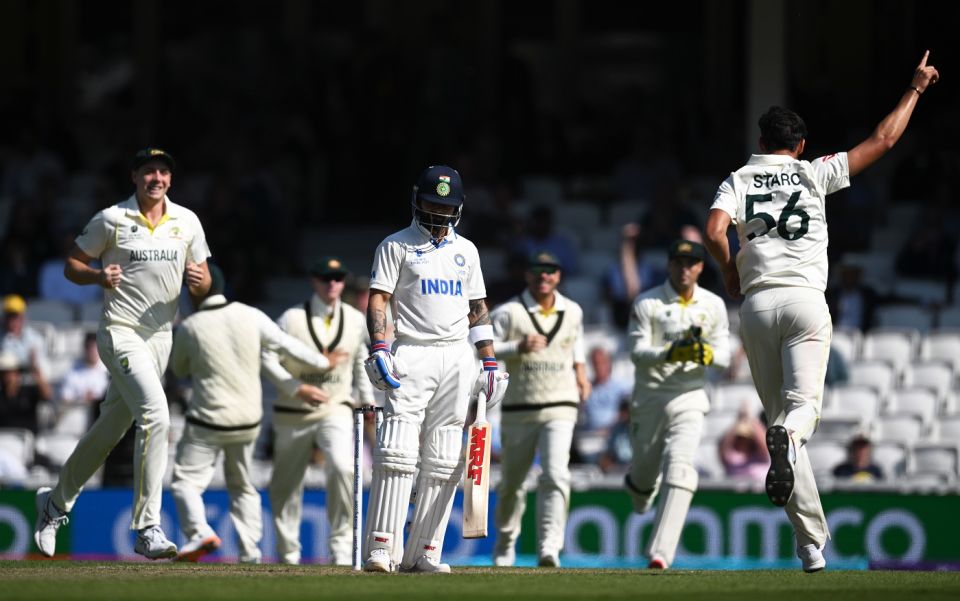 Mitchell Starc celebrates after dismissing Virat Kohli