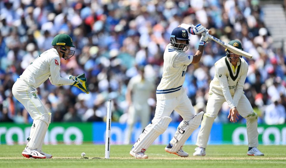 Ajinkya Rahane punches Nathan Lyon through the off side