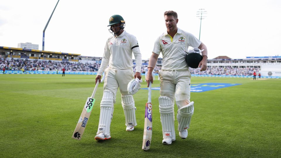 Usman Khawaja and David Warner walk from the ground at stumps