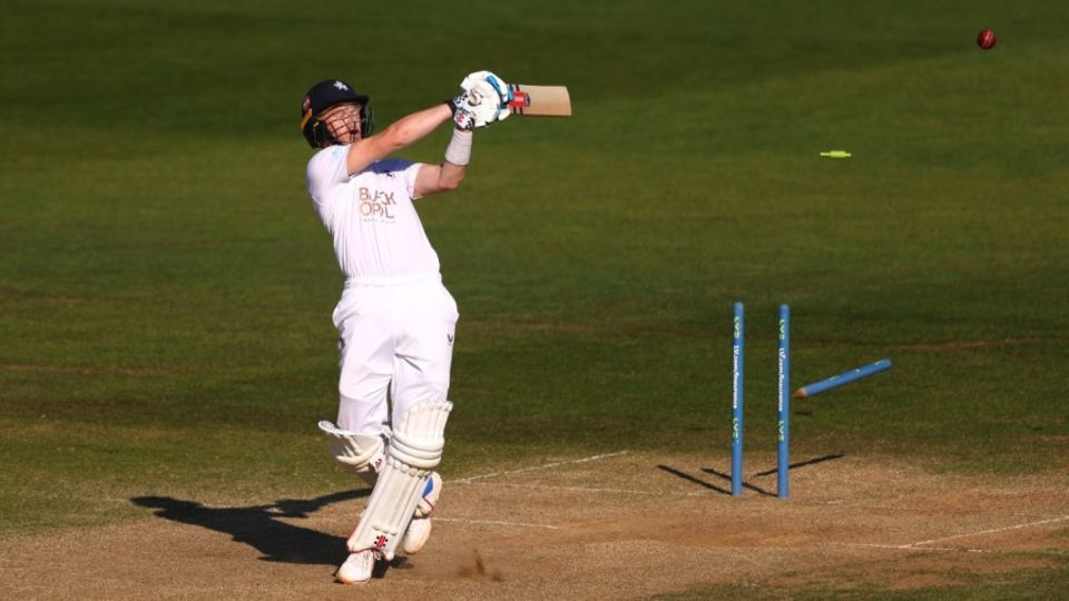 Sam Billings swings across the line and loses his middle stump