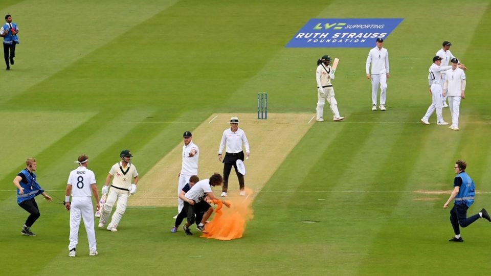 Lord's security personnel tackle a 'Just Stop Oil' pitch invader