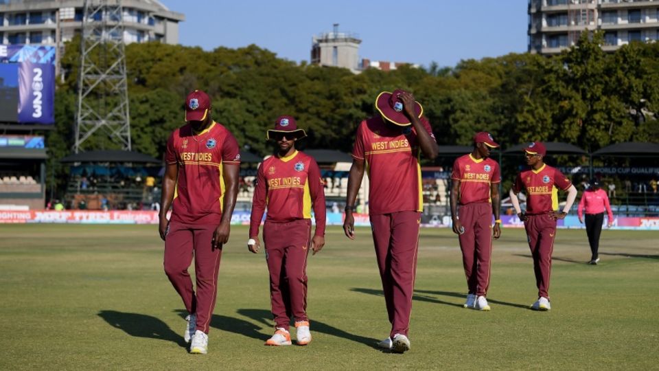 Dejected West Indies players leave the field