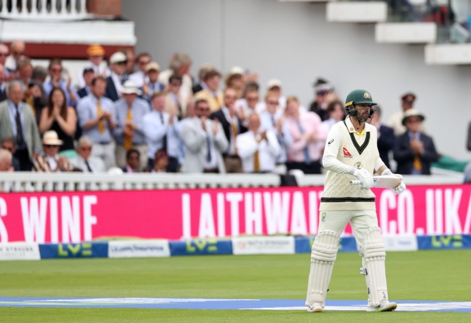 Nathan Lyon hobbles out to bat to a standing ovation