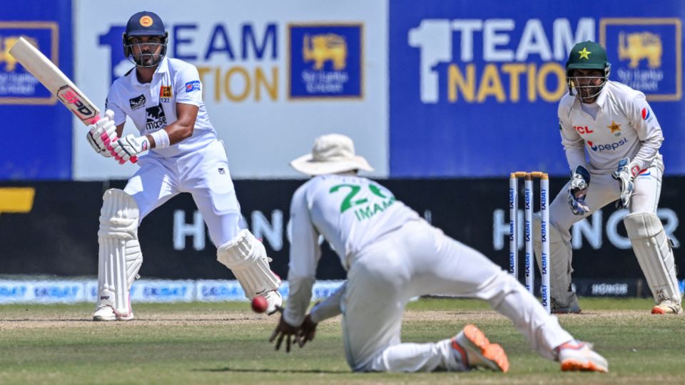Imam-ul-Haq dives forward to take a fine catch to dismiss Dinesh Chandimal