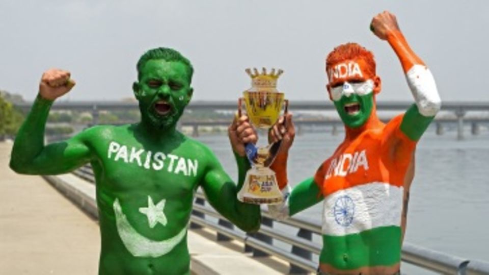 Fans of India and Pakistan hold a cut-out of the Asia Cup trophy in Ahmedabad