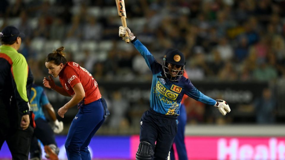 Harshitha Samarawickrama wheels past a cautious Kate Cross in celebration