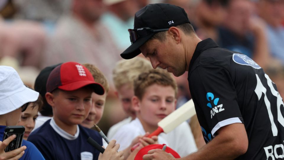 Trent Boult signs autographs during a break in play at the Ageas Bowl