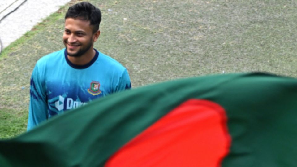 Shakib Al Hasan beams behind the Bangladesh flag