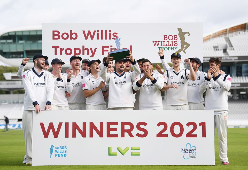 Will Rhodes holds aloft the Bob Willis Trophy