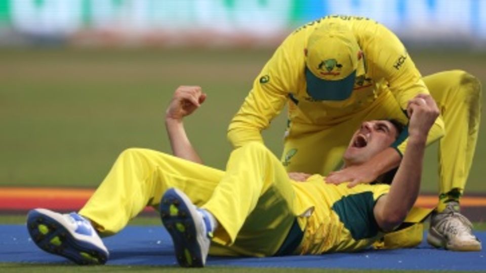 Pat Cummins exults after a quite stunning take to remove Quinton de Kock