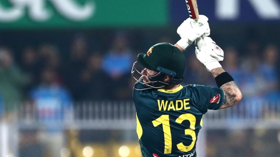 There it goes: Mathew Wade launches the ball back