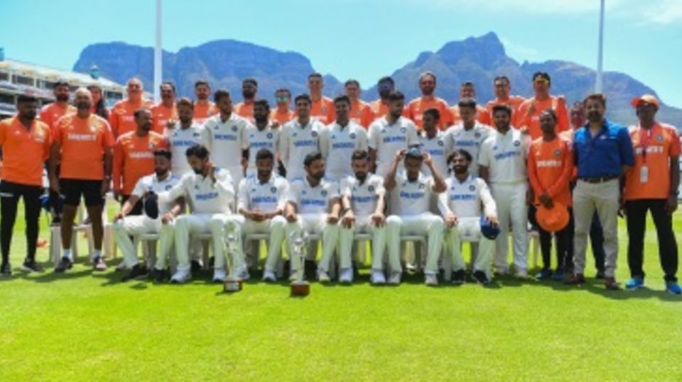 India's players and staff pose with the Table Mountain at the back