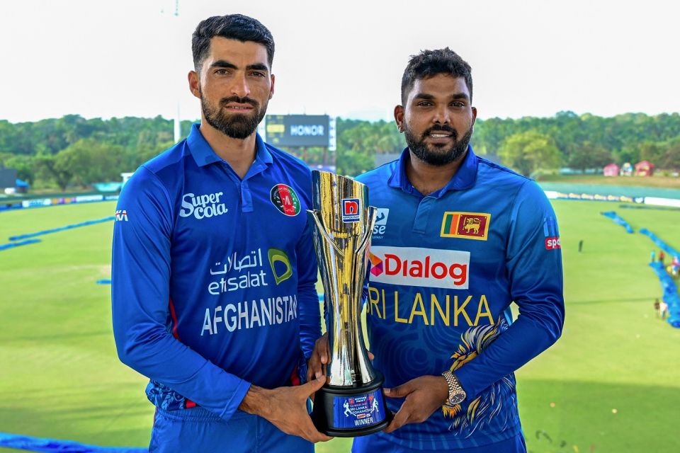 Ibrahim Zadran and Wanindu Hasaranga with the T20I series trophy their teams will be contesting over the next week