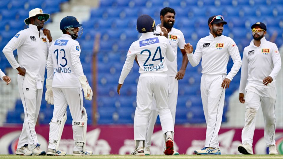 Prabath Jayasuriya celebrates with team-mates after bowling Mahmudul Hasan Joy