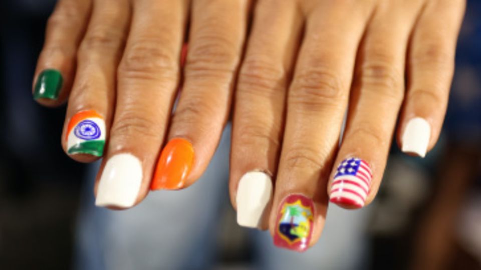 A fan displays their World Cup themed nail art