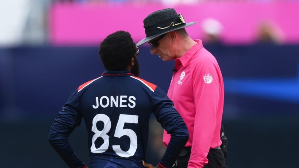 USA captain Aaron Jones chats with umpire Paul Reiffel after his team was penalised five runs