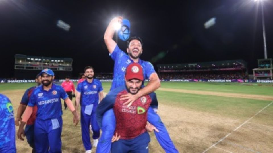 Gulbadin Naib is carried on his shoulders by Afghanistan's bowling coach Hamid Hassan