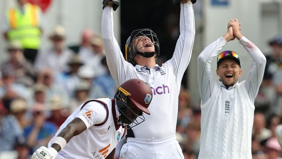 Jamie Smith and Joe Root go up in unison to celebrate Kirk McKenzie's dismissal