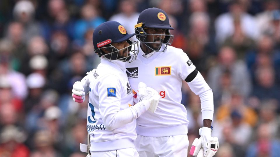 Dhananjaya de Silva is congratulated by Milan Rathnayake after reaching his half-century