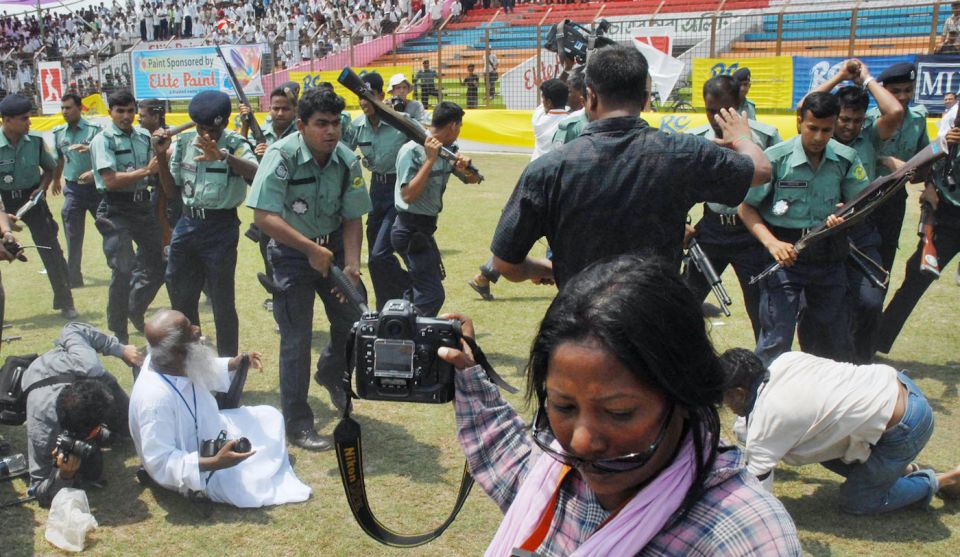 A photographer captures the chaos at the stadium even as the police beat back journalists