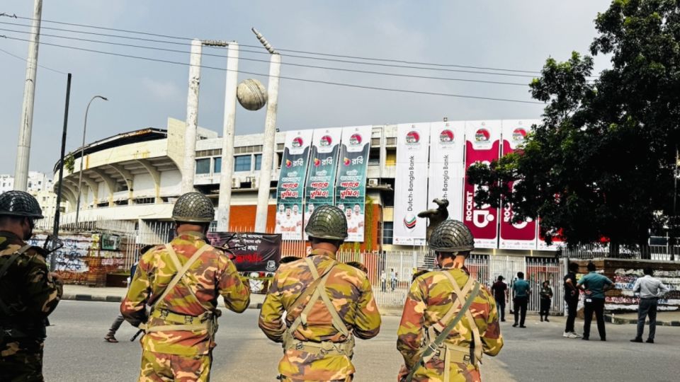 Security officials stand guard outside the Shere Bangla National Stadium
