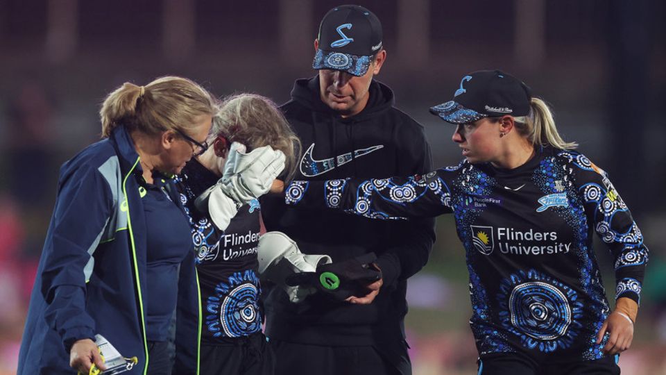 Bridget Patterson leaves the field after taking a blow in the face