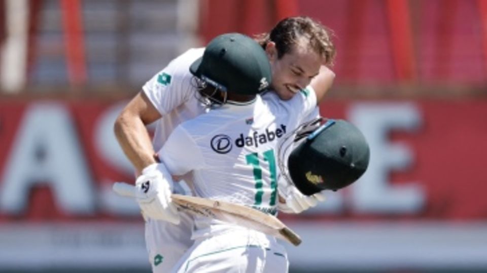 Tristan Stubbs gets a hug from his captain after reaching his century