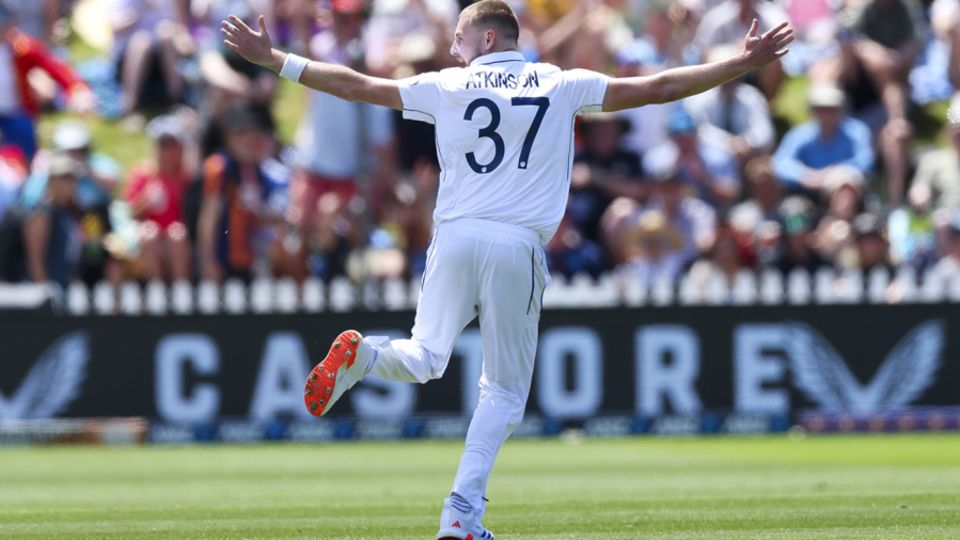 Gus Atkinson spreads his arms after pinning Tim Southee for his hat-trick