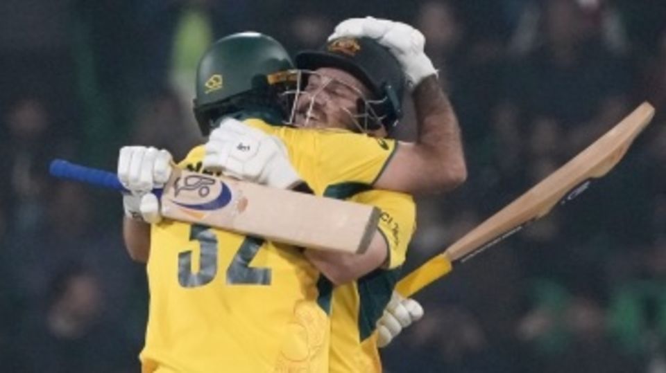 Josh Inglis and Glenn Maxwell embrace after Australia's win