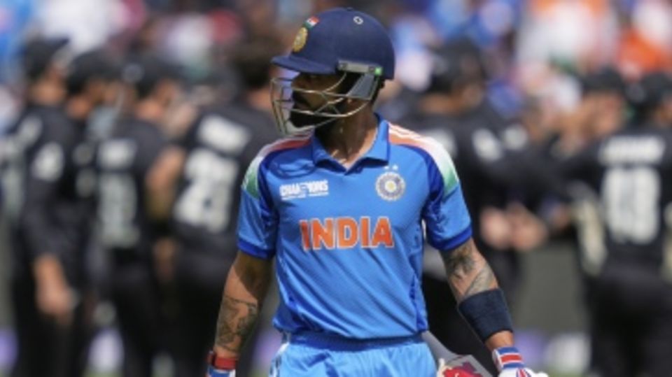 Virat Kohli walks back, having fallen to a magic catch from Glenn Phillips