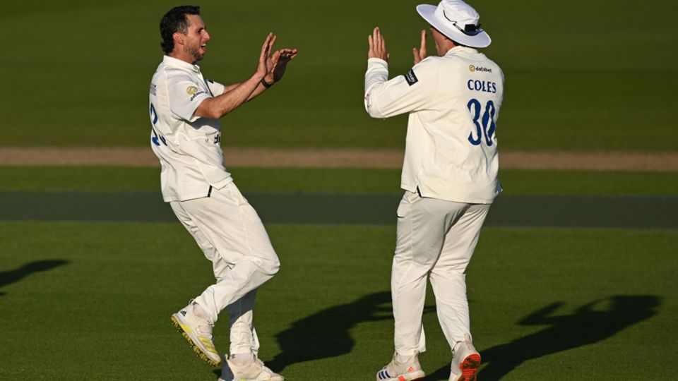 Hudson-Prentice (left) celebrates a wicket with James Coles
