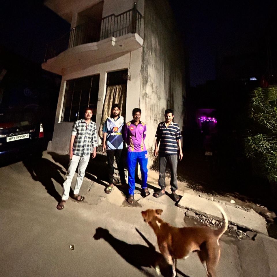 Naeem Ansari (extreme left) poses with members of the family in front of the old house Zeeshan is helping repair