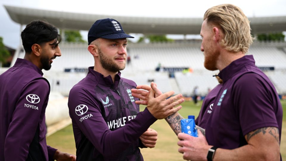 Cook is congratulated by Ben Stokes after receiving his first cap