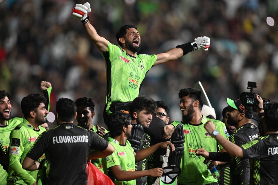 The Qalandars players carry Sikandar Raza off the field after the win was sealed