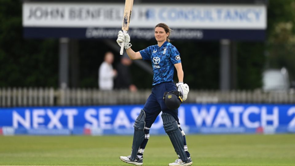 Amy Jones celebrates after reaching her century