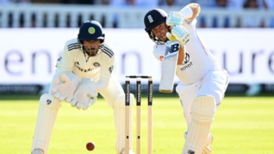 Joe Root punches the ball away