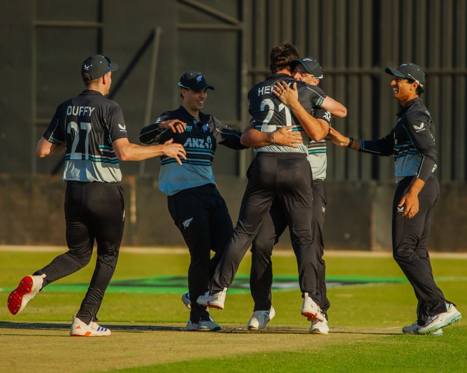 Matt Henry is mobbed by his mates after defending seven runs in the final over