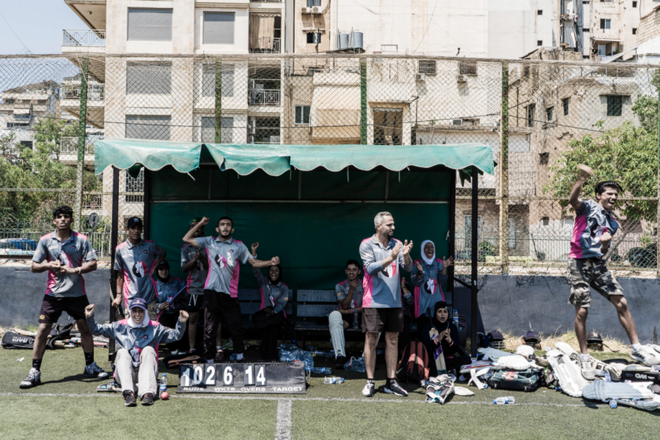 Syrian players in the dugout cheer for their team during the Lebanon T20 tournament against teams from the subcontinent